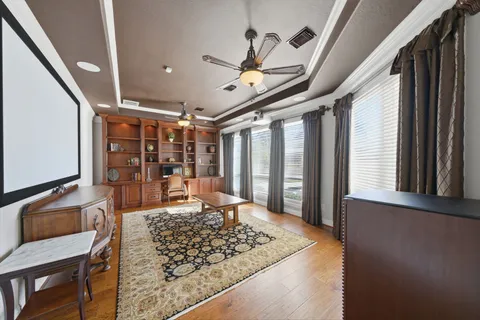 a view of a livingroom with furniture wooden floor and a rug