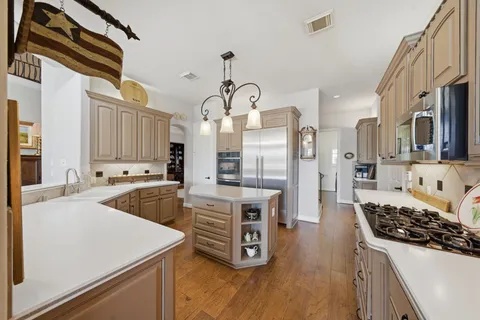 a living room with furniture a fireplace and a floor to ceiling window