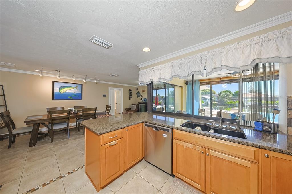 914 Chipaway Drive Apollo Beach, FL 33572 - Photo 11 of 49 a kitchen with granite countertop a sink and white cabinets
