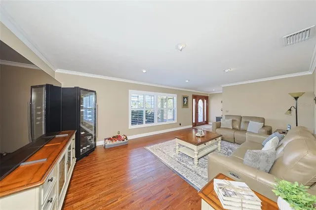 a bedroom with a large bed a flat tv screen and dresser