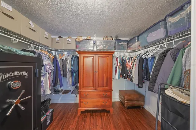 a large bathroom with a granite countertop tub sink shower and mirror