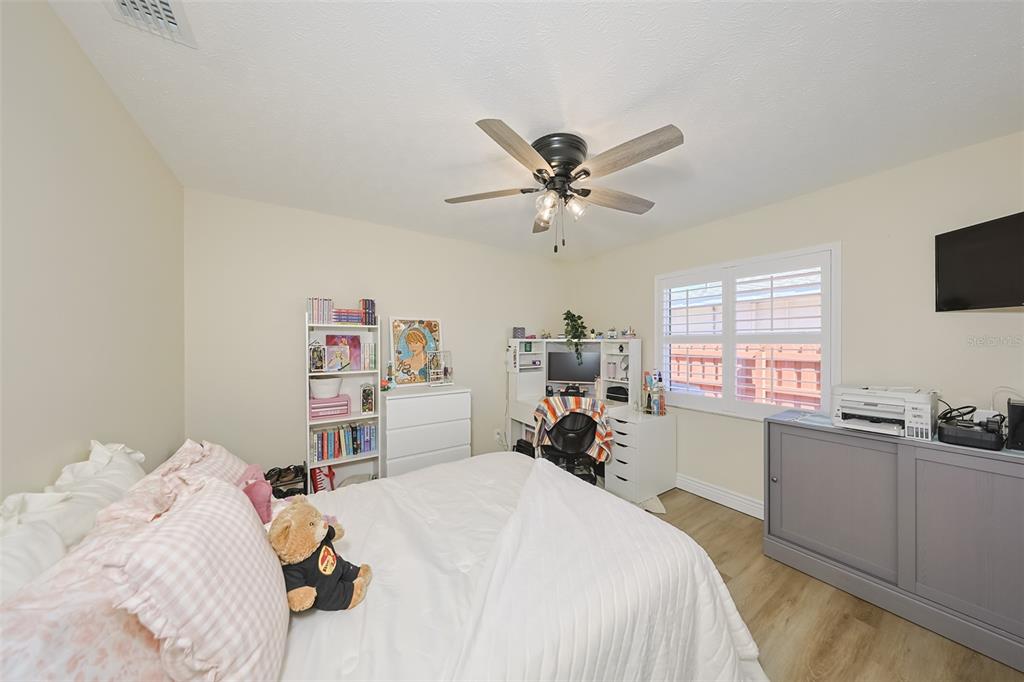 914 Chipaway Drive Apollo Beach, FL 33572 - Photo 21 of 49 a bed room with a bed a computer on a desk and a window