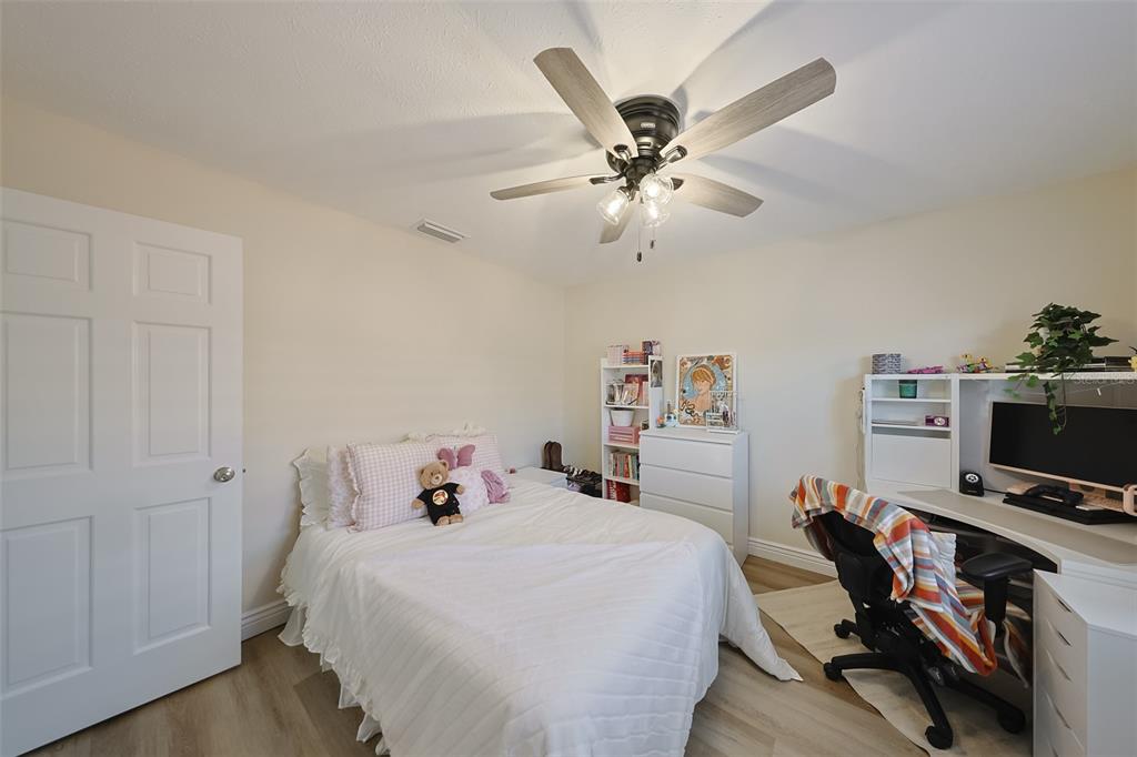 914 Chipaway Drive Apollo Beach, FL 33572 - Photo 37 of 49 a bedroom with a bed and a chandelier