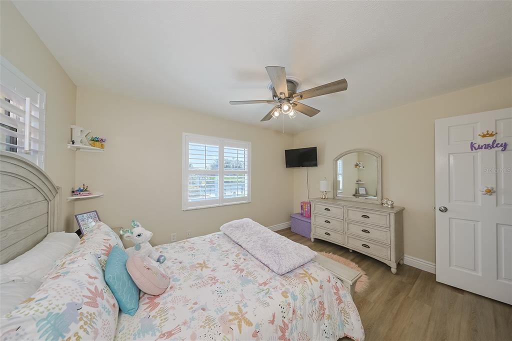 914 Chipaway Drive Apollo Beach, FL 33572 - Photo 38 of 49 a bedroom with a bed and a chandelier