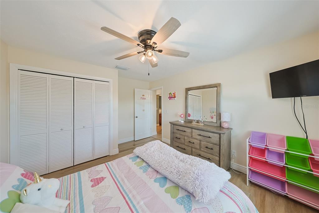 914 Chipaway Drive Apollo Beach, FL 33572 - Photo 39 of 49 a bedroom with a bed a chandelier and dresser