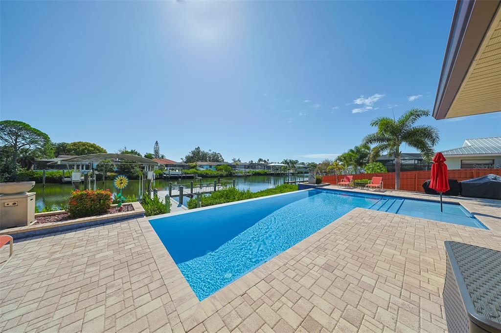914 Chipaway Drive Apollo Beach, FL 33572 - Photo 43 of 49 a view of swimming pool with seating area and trees in the background
