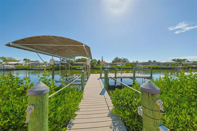 a view of a lake with a floor to ceiling window next to a yard