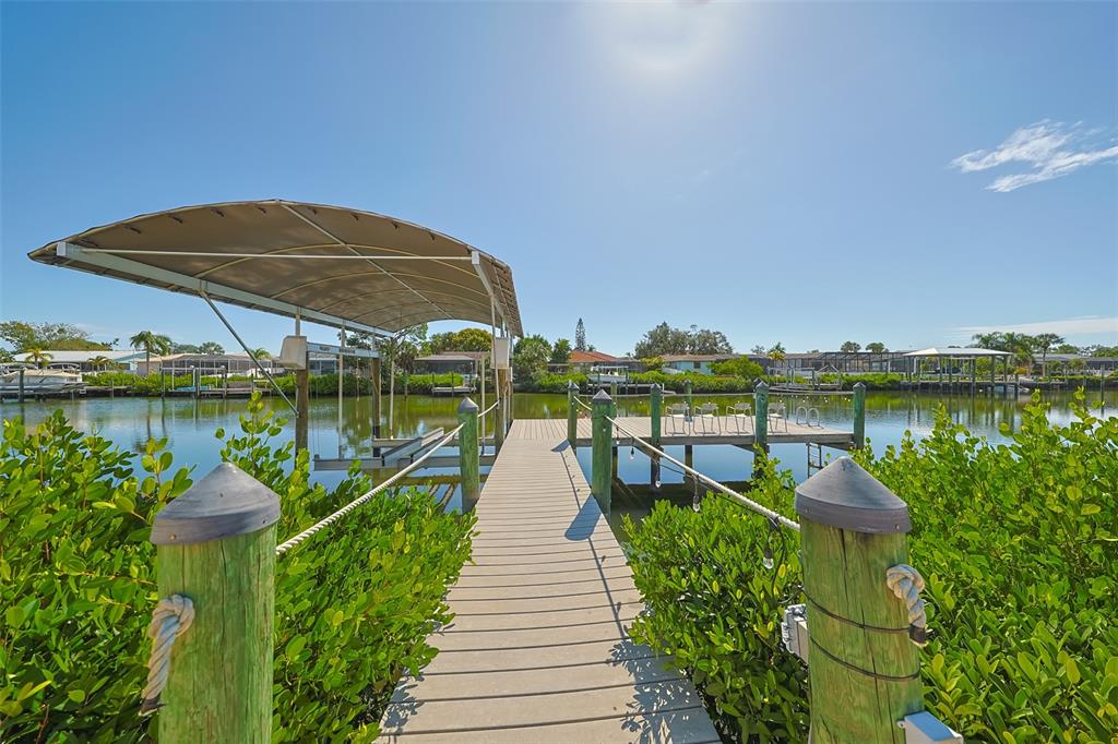 914 Chipaway Drive Apollo Beach, FL 33572 - Photo 7 of 49 a view of a lake with a floor to ceiling window next to a yard