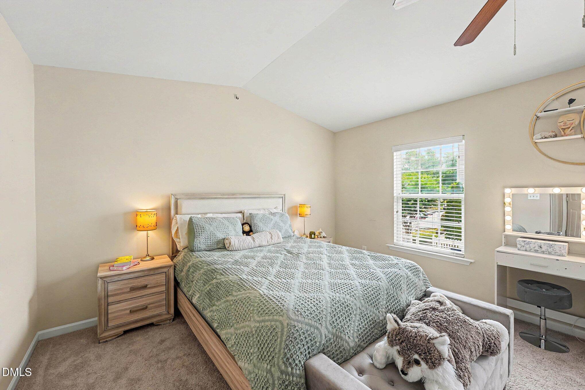 1130 Renewal Place, Unit 106 Raleigh, NC 27603 - Photo 13 of 34 a bedroom with a bed and a window