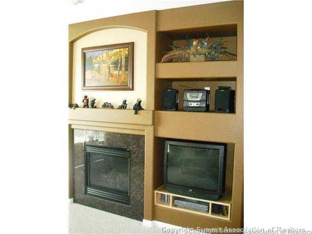 110 Beaver Lodge Road, Unit 103 Frisco, CO 80443 - Photo 3 of 25 a living room with a fireplace and a fireplace