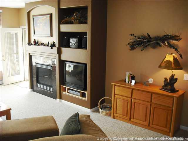 110 Beaver Lodge Road, Unit 103 Frisco, CO 80443 - Photo 4 of 25 a living room with furniture a fireplace and a flat screen tv