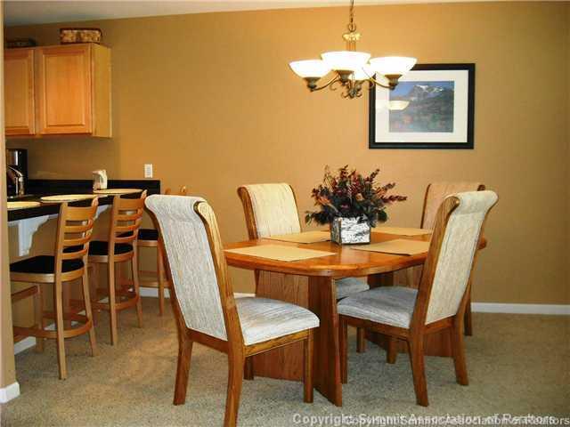 110 Beaver Lodge Road, Unit 103 Frisco, CO 80443 - Photo 6 of 25 a dining room with furniture and a chandelier