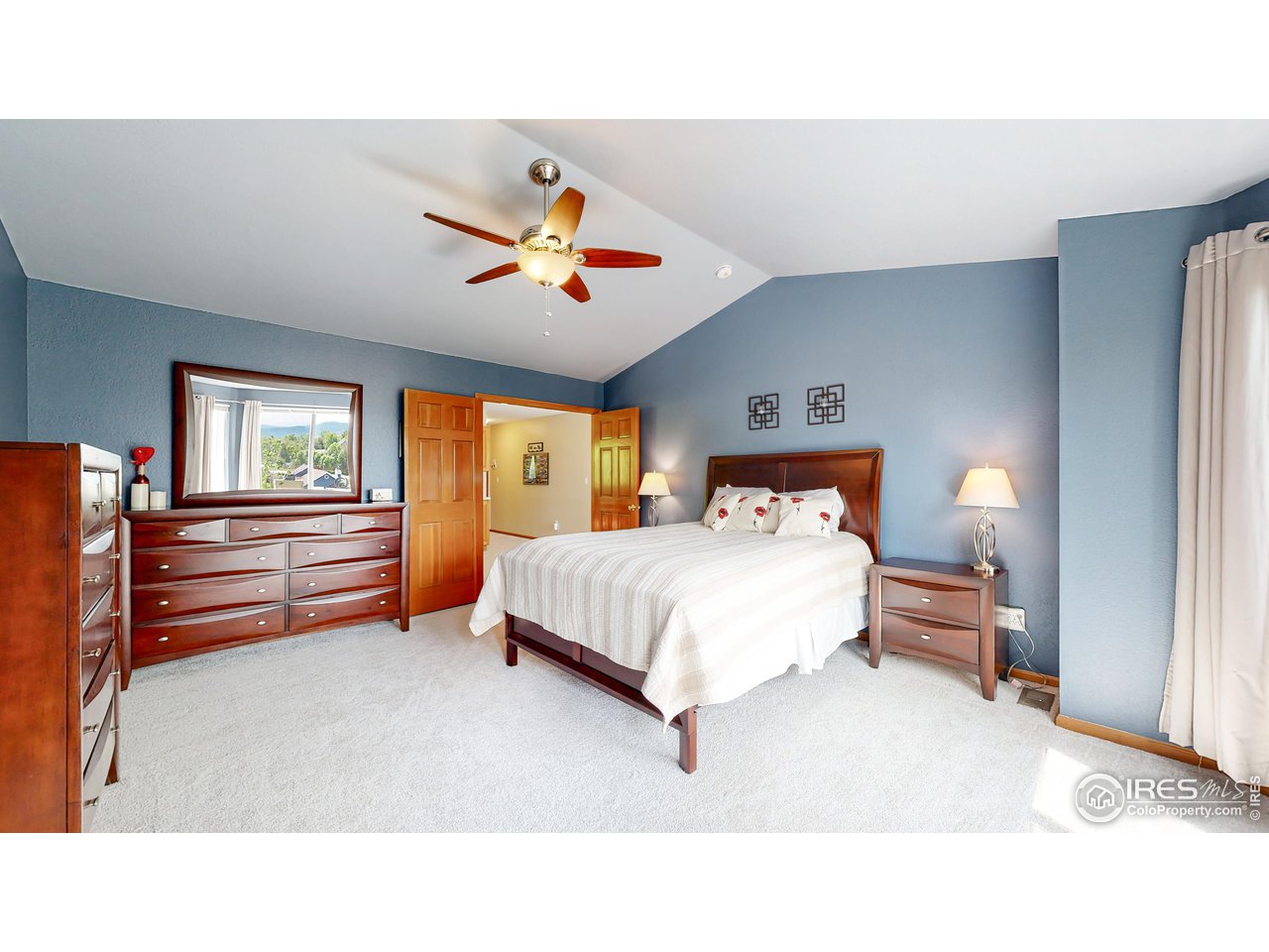 9951 South Spring Hill Place Highlands Ranch, CO 80129 - Photo 13 of 40 a bedroom with a bed and a chandelier