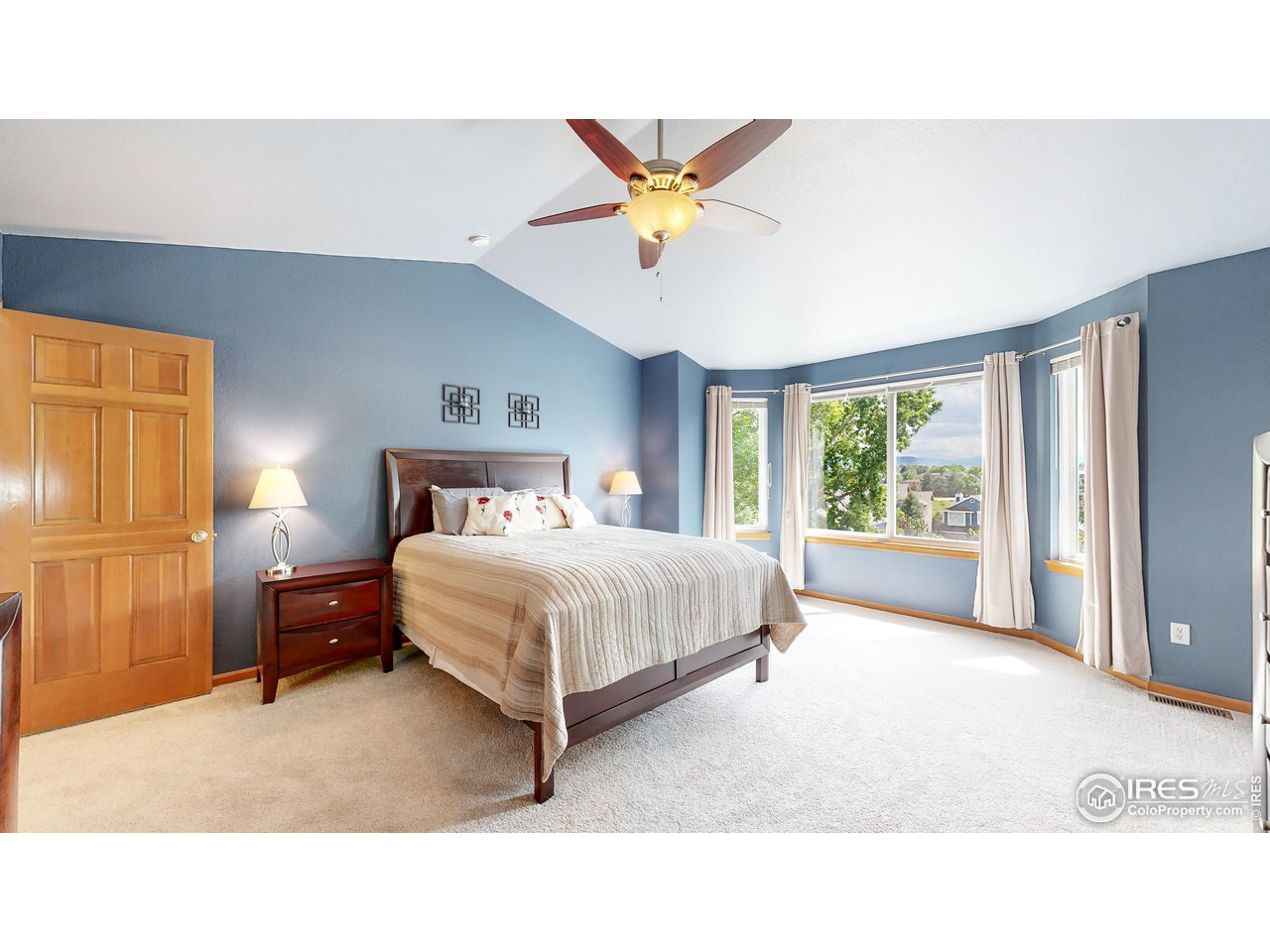 9951 South Spring Hill Place Highlands Ranch, CO 80129 - Photo 14 of 40 a bedroom with a bed and a chandelier