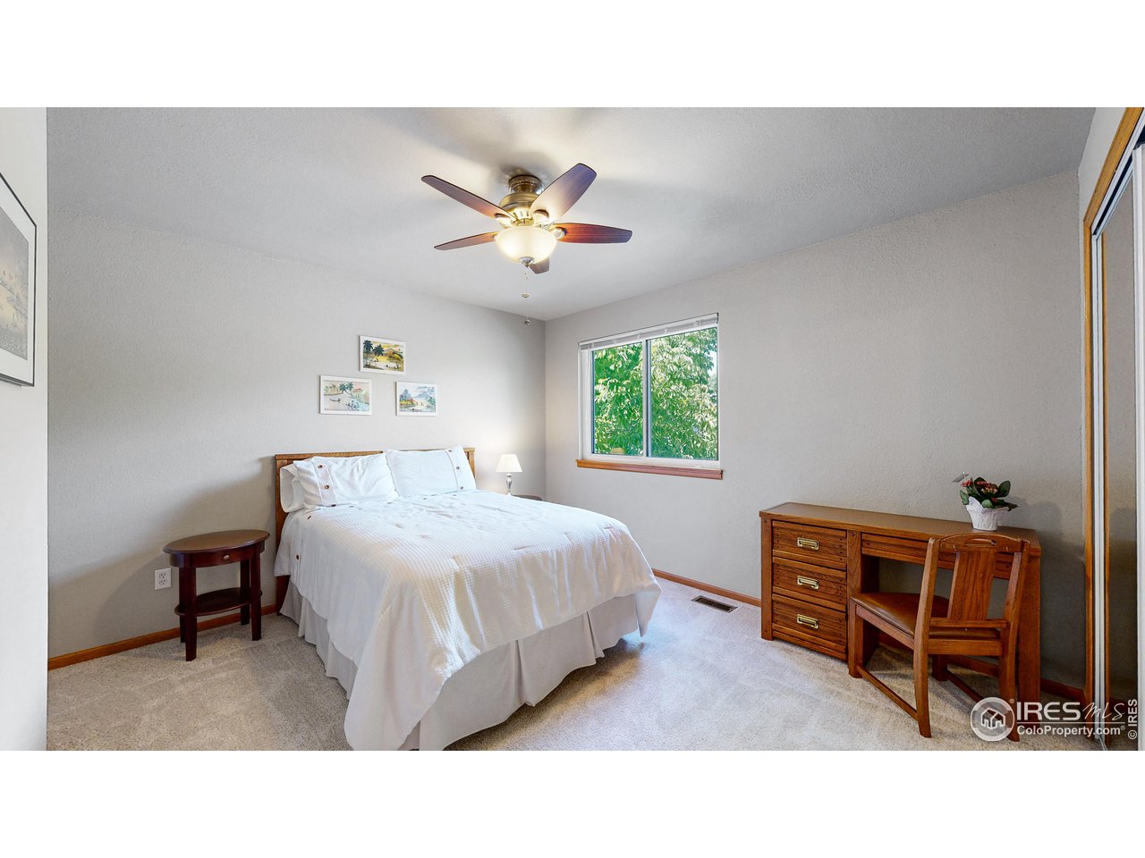9951 South Spring Hill Place Highlands Ranch, CO 80129 - Photo 17 of 40 a bedroom with a bed and a chandelier