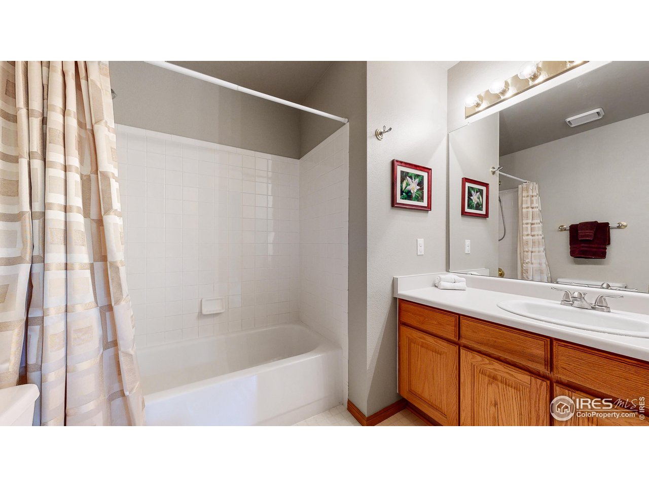 9951 South Spring Hill Place Highlands Ranch, CO 80129 - Photo 18 of 40 a bathroom with a sink tub shower and a mirror