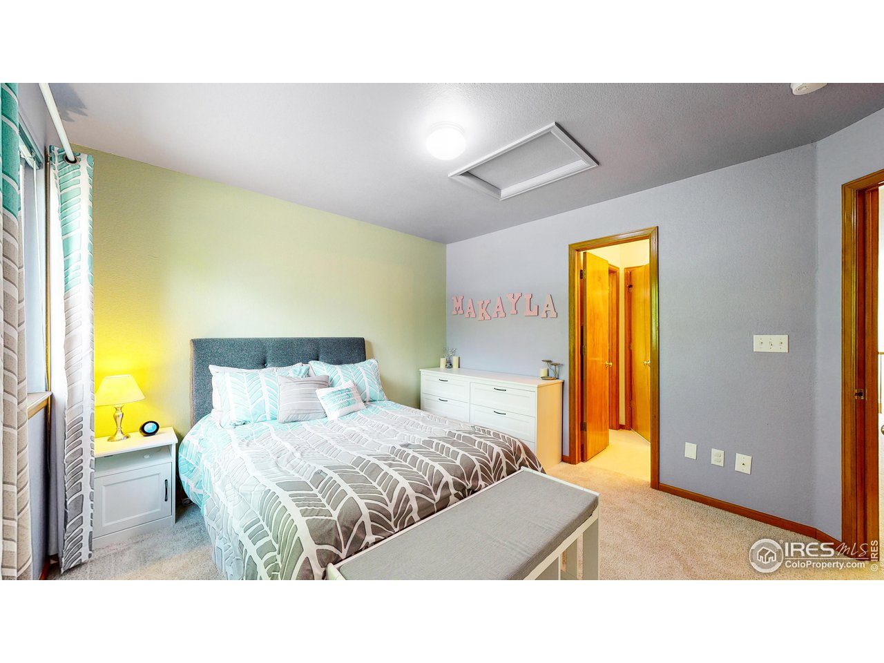 9951 South Spring Hill Place Highlands Ranch, CO 80129 - Photo 19 of 40 a living room with a bed and a dresser