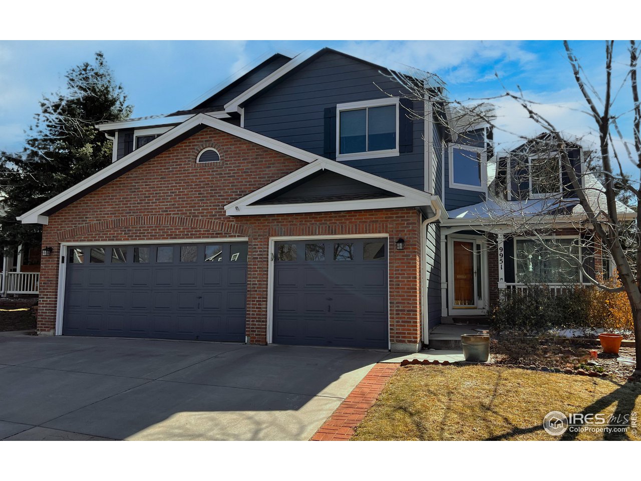 9951 South Spring Hill Place Highlands Ranch, CO 80129 - Photo 2 of 40 a front view of a house with a yard