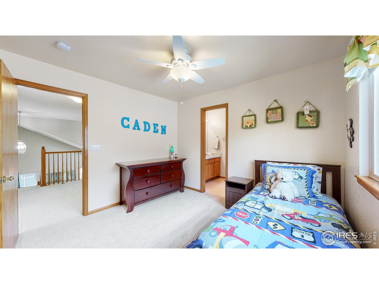 9951 South Spring Hill Place Highlands Ranch, CO 80129 - Photo 20 of 40 a bedroom with a bed and a chandelier