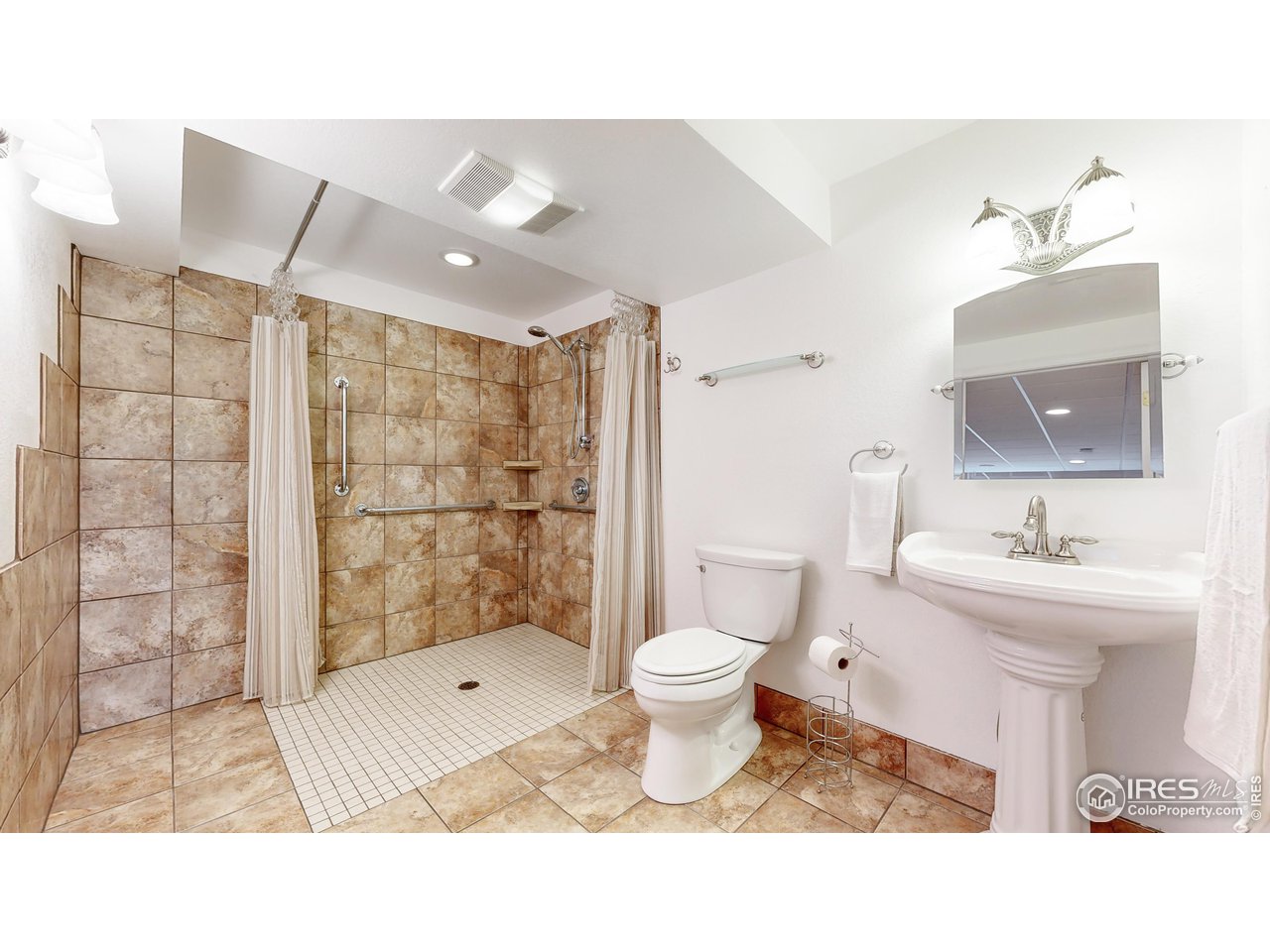 9951 South Spring Hill Place Highlands Ranch, CO 80129 - Photo 27 of 40 a bathroom with a sink toilet a mirror and shower