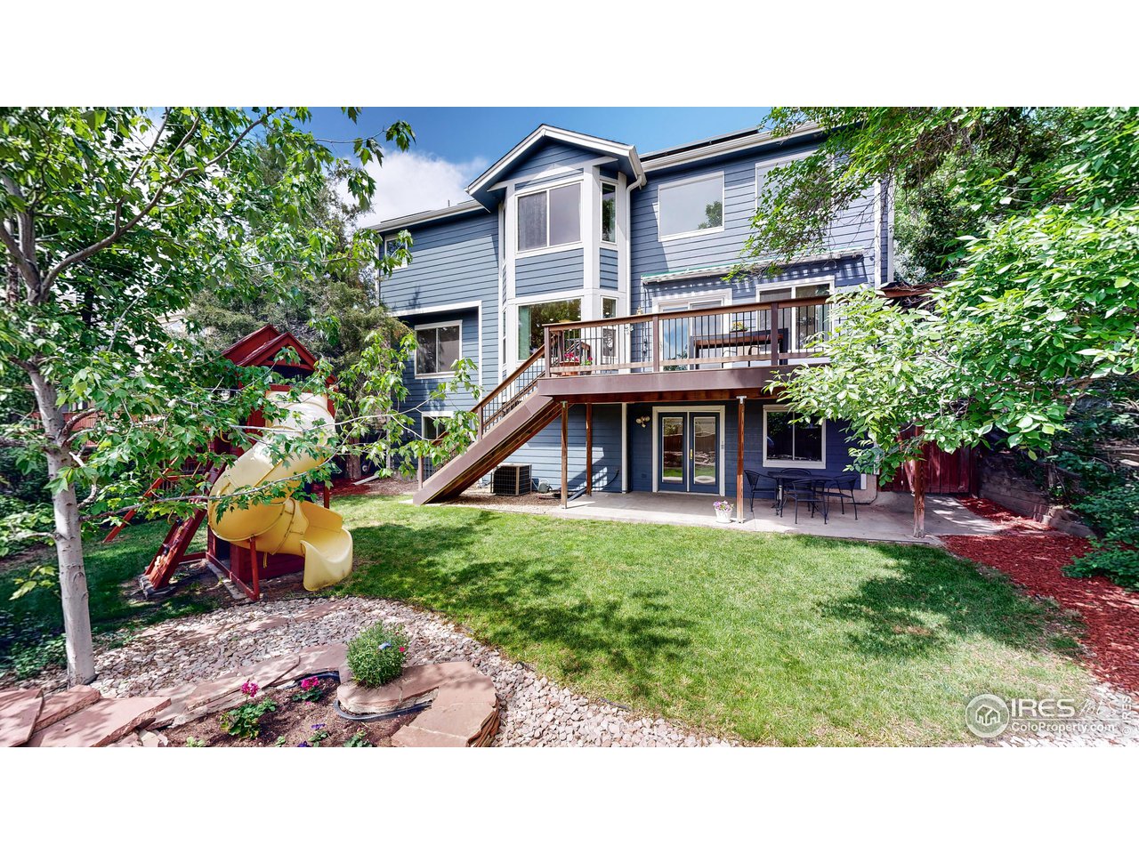 9951 South Spring Hill Place Highlands Ranch, CO 80129 - Photo 33 of 40 a front view of a house with a yard