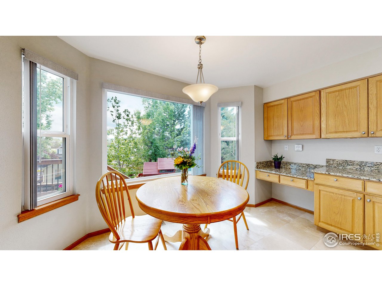 9951 South Spring Hill Place Highlands Ranch, CO 80129 - Photo 4 of 40 a kitchen with a table chairs sink and cabinets