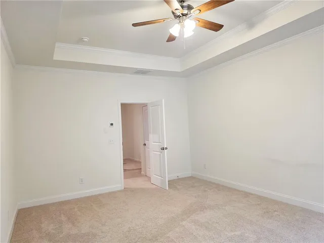 an empty room with closet and a chandelier fan