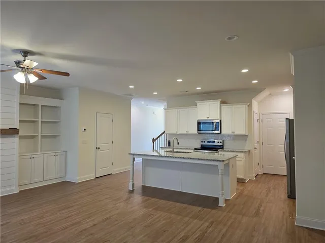 a kitchen with kitchen island a sink stainless steel appliances and cabinets