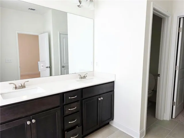 a bathroom with a double vanity sink and a mirror