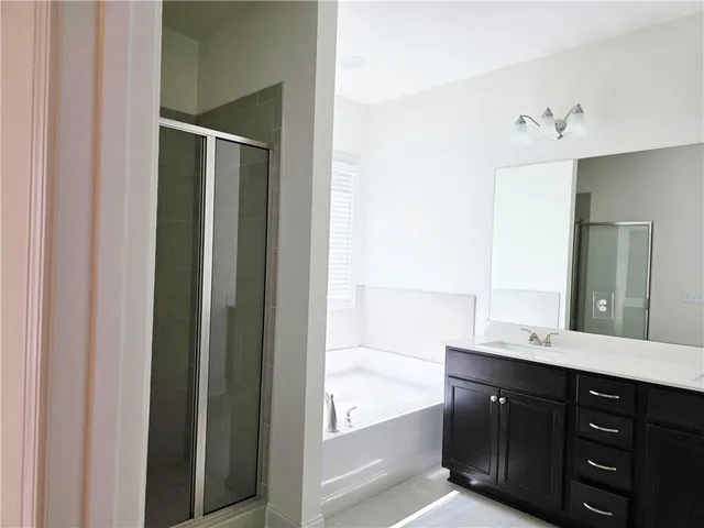 a bathroom with a double vanity sink and mirror