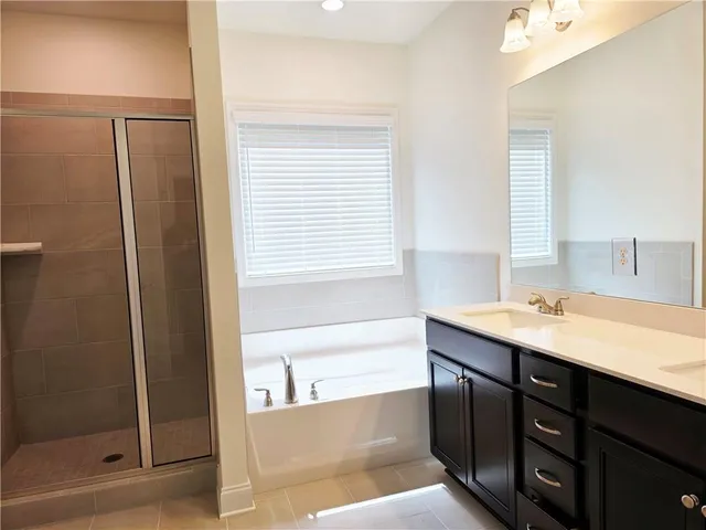 a bathroom with a tub sink and a mirror