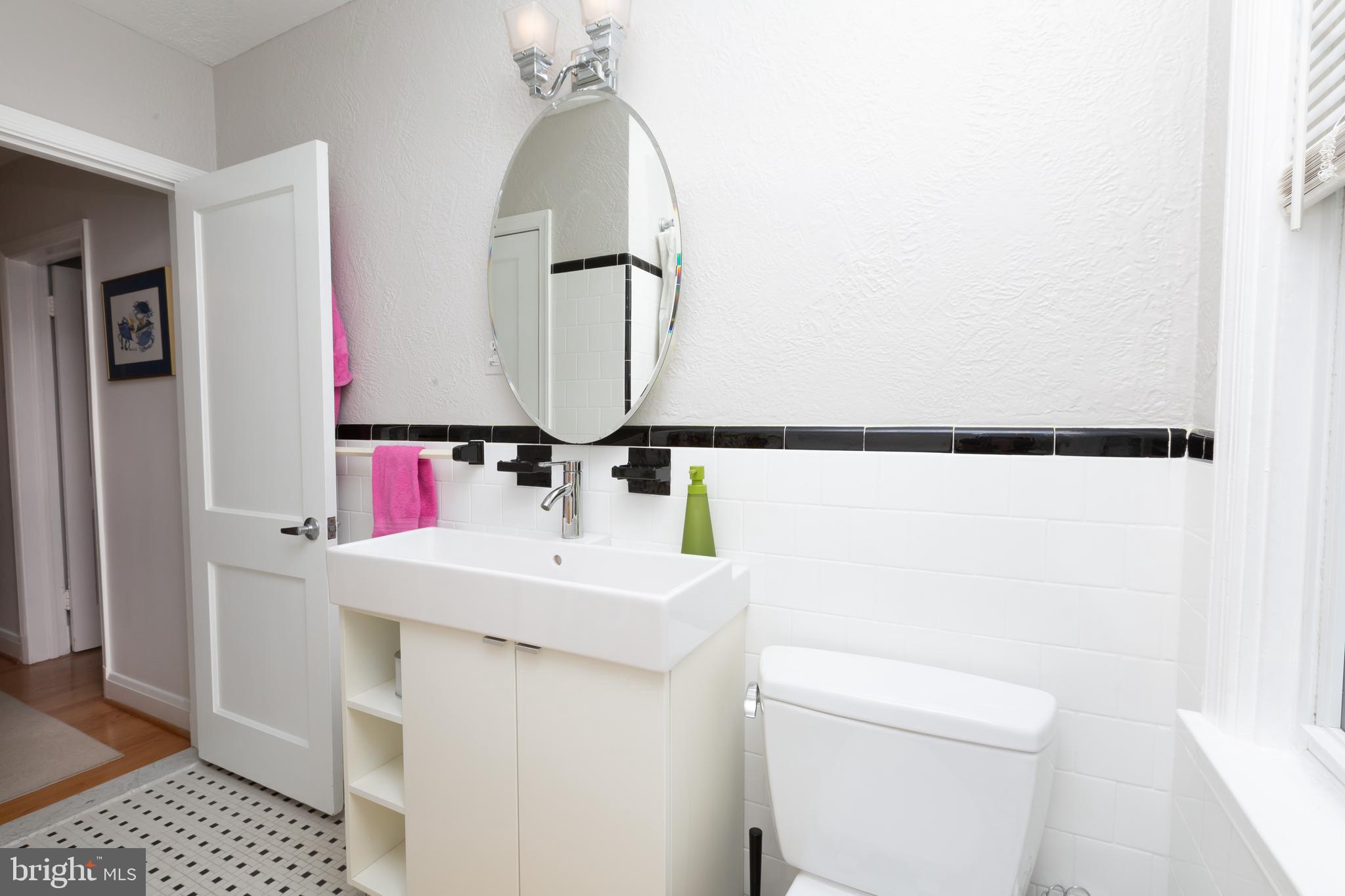 165 Stanmore Road Baltimore, MD 21212 - Photo 22 of 30 a bathroom with a sink vanity and a mirror