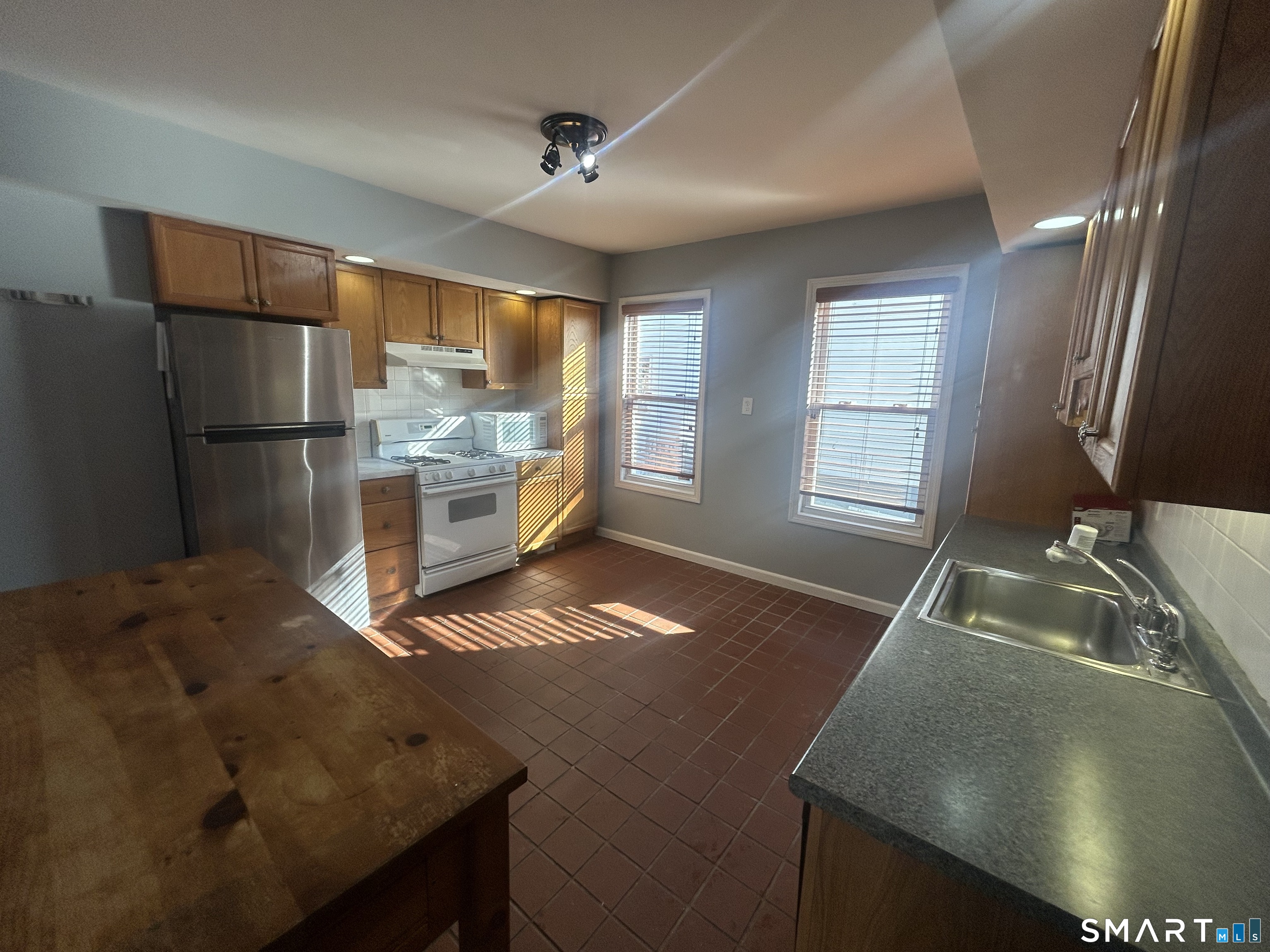 143 Wilson Street Bridgeport, CT 06605 - Photo 3 of 12 a kitchen with refrigerator and window