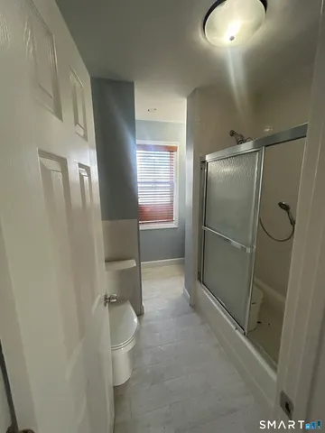 a bathroom with a shower and a toilet