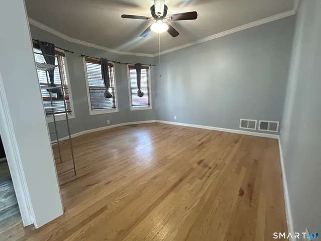 wooden floor in an empty room with a window