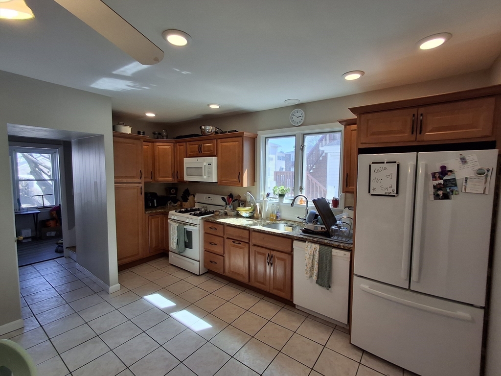 24 French Street, Unit 24 Watertown, MA 02472 - Photo 3 of 9 a kitchen with stainless steel appliances granite countertop a refrigerator and a sink