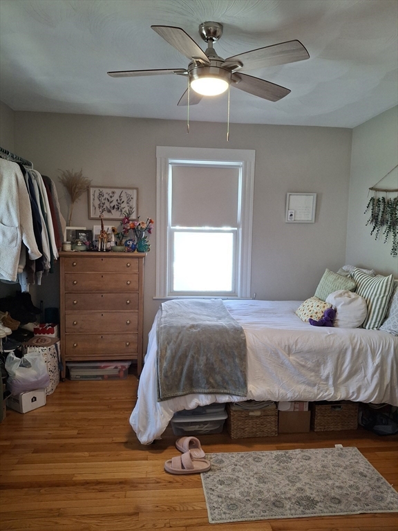 24 French Street, Unit 24 Watertown, MA 02472 - Photo 5 of 9 a bedroom with a bed and wooden floor