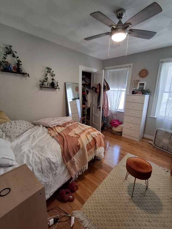 24 French Street, Unit 24 Watertown, MA 02472 - Photo 7 of 9 a bedroom with bed and a chandelier