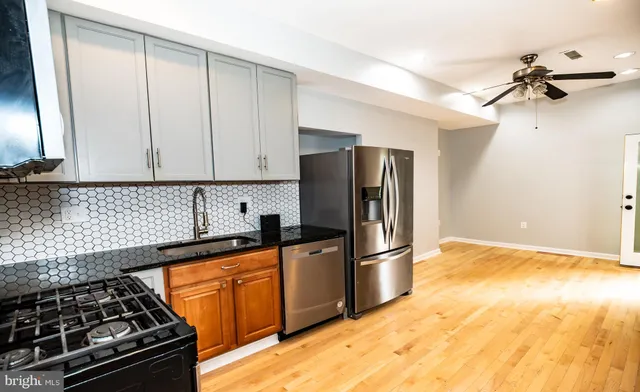 a kitchen with granite countertop a stove and a refrigerator