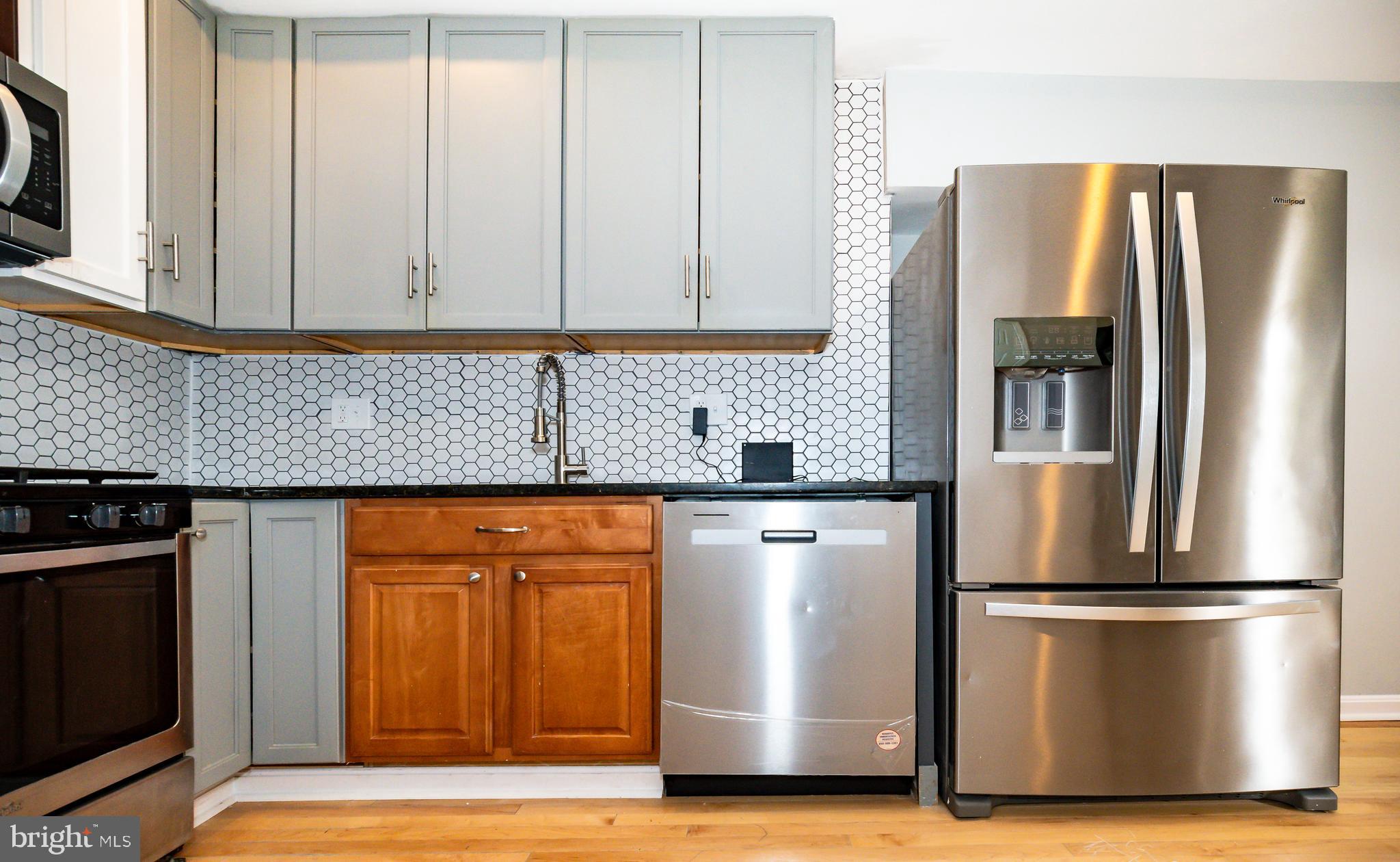 1427 New Jersey Avenue Northwest Washington, DC 20001 - Photo 18 of 29 a kitchen with stainless steel appliances granite countertop a refrigerator and a stove