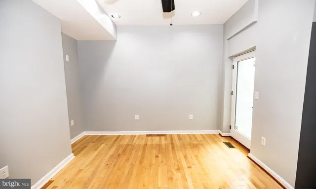 a view of a room with wooden floor and bathroom