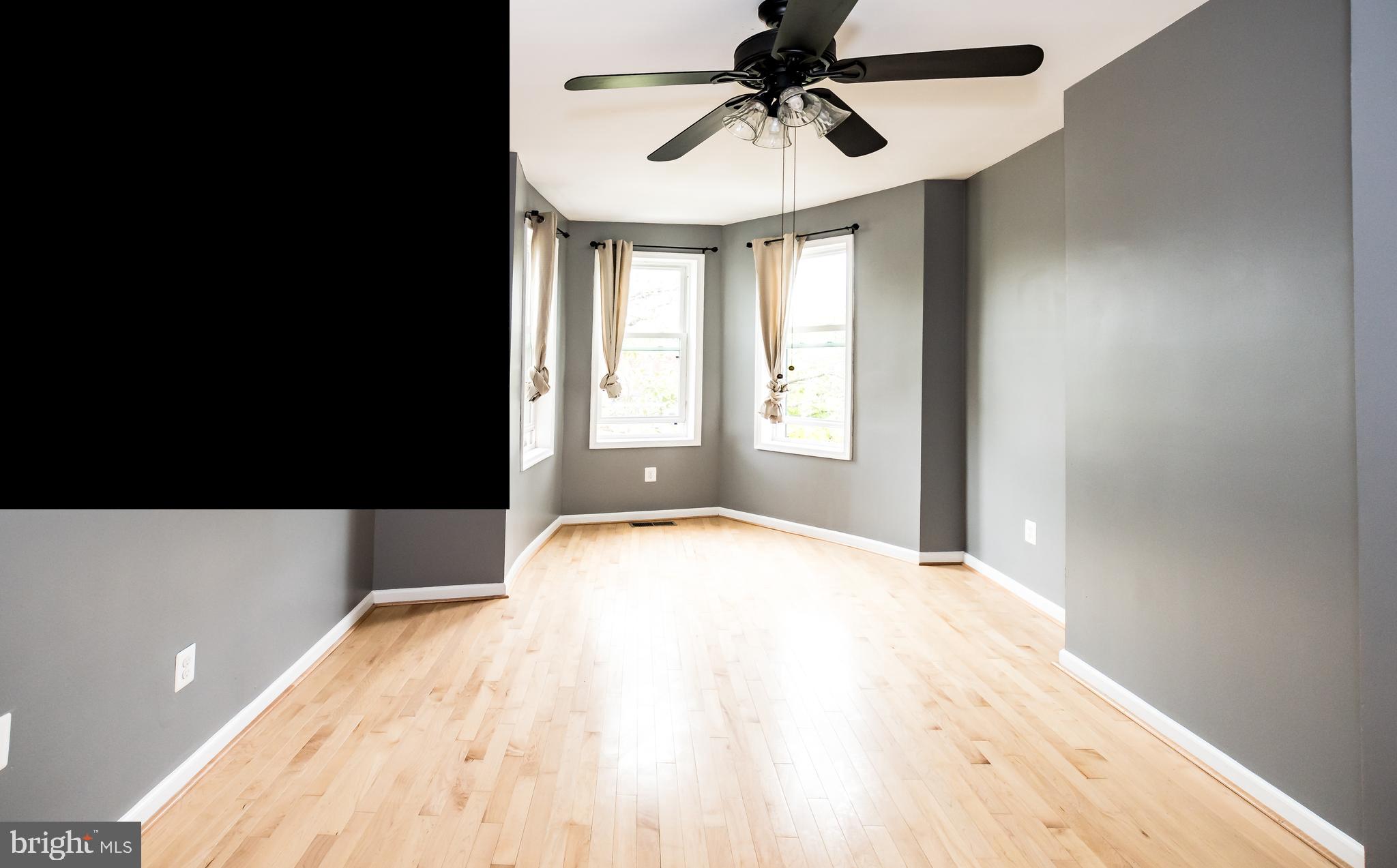 1427 New Jersey Avenue Northwest Washington, DC 20001 - Photo 4 of 29 a bedroom with a bed and a chandelier