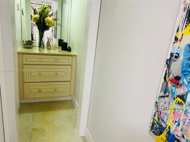 a bedroom with a bed and painting on the wall