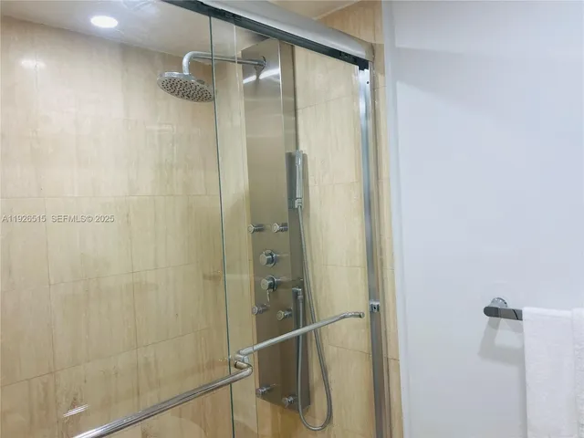 a bathroom with a glass shower door