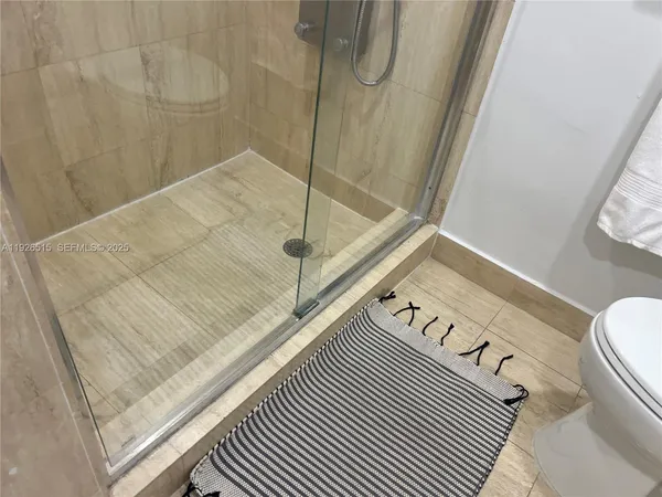 a bathroom with a shower and toilet