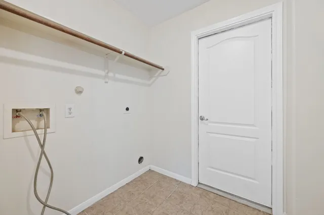 a view of small space with racks on the wall and a window