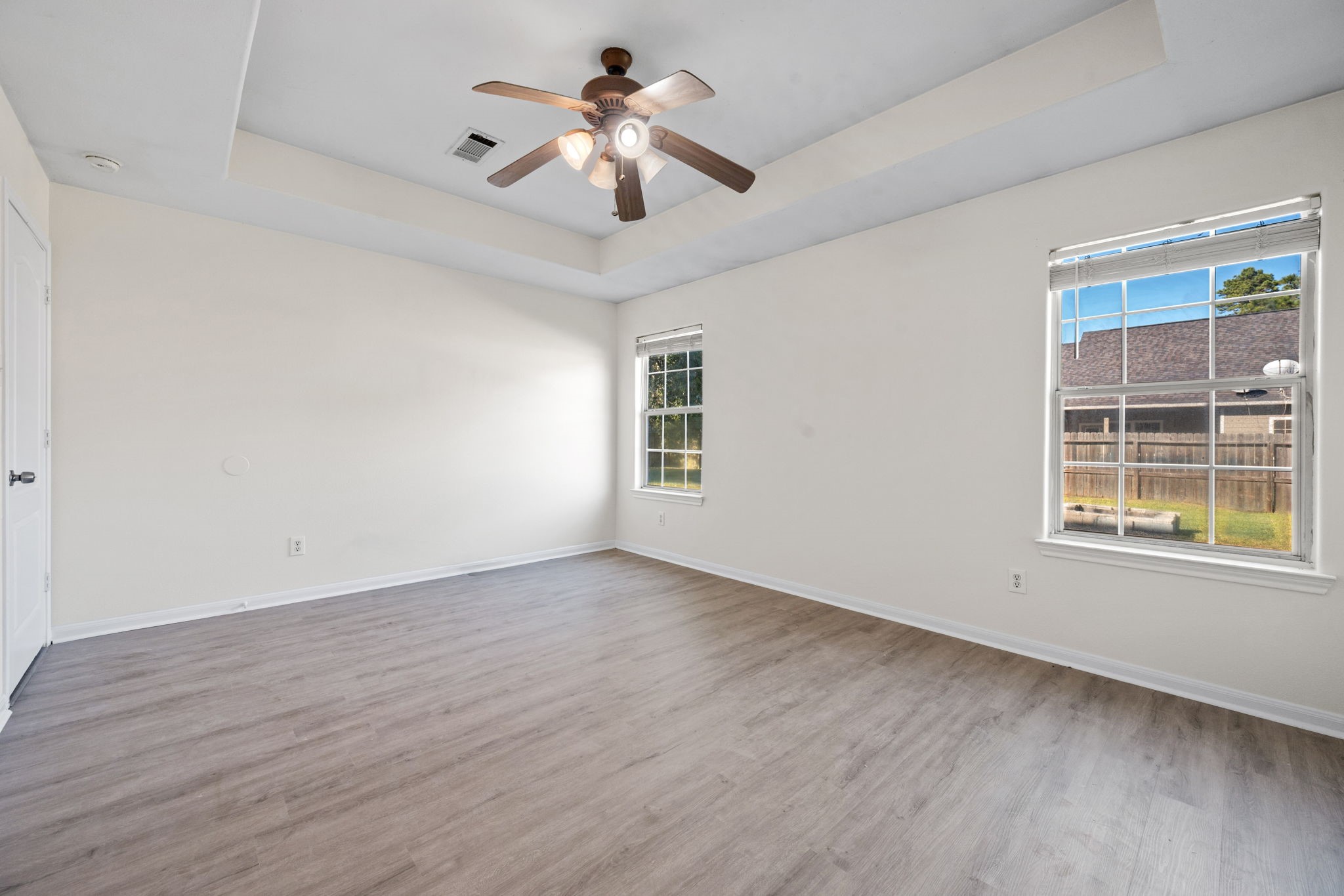 25785 Hickory Lane Splendora, TX 77372 - Photo 19 of 28 a view of an empty room with a window and wooden floor