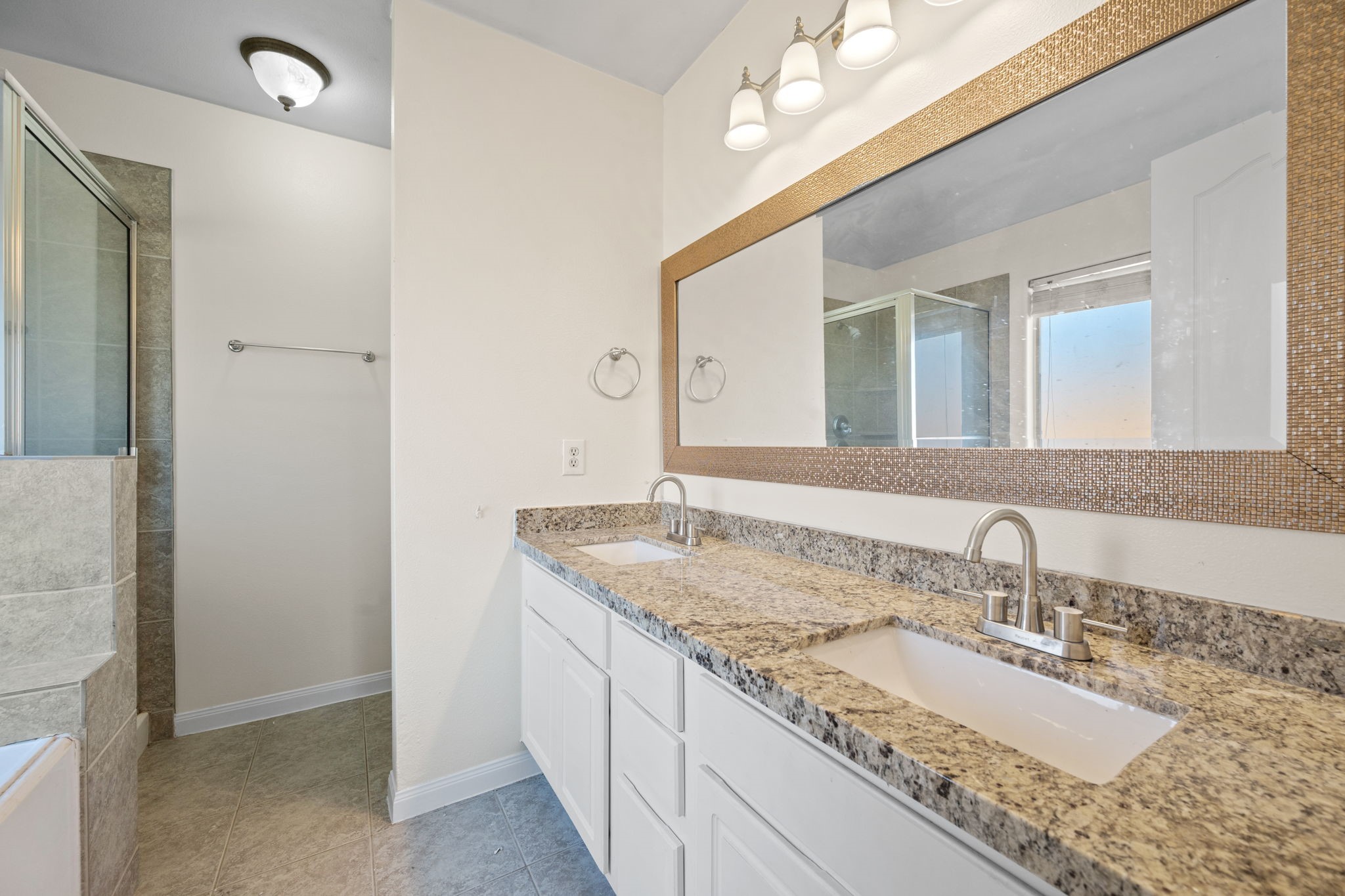 25785 Hickory Lane Splendora, TX 77372 - Photo 20 of 28 a bathroom with a granite countertop sink and a mirror