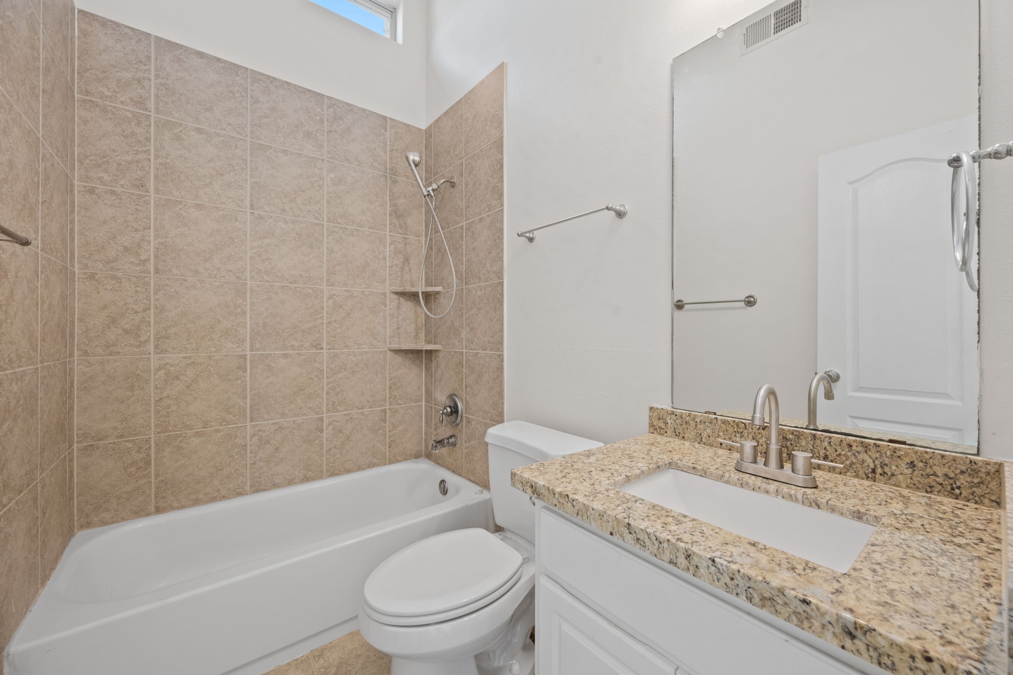 25785 Hickory Lane Splendora, TX 77372 - Photo 26 of 28 a bathroom with a granite countertop toilet a sink and a bathtub