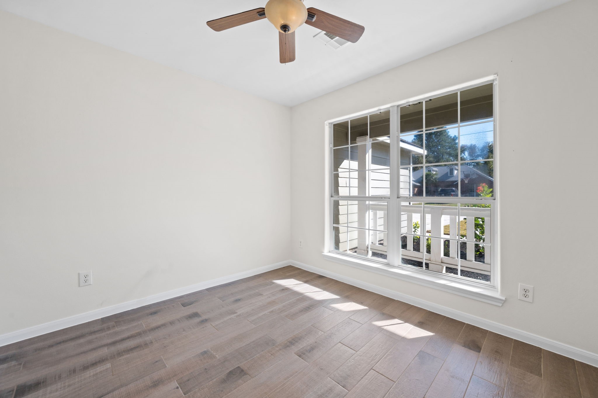 25785 Hickory Lane Splendora, TX 77372 - Photo 4 of 28 an empty room with wooden floor and windows